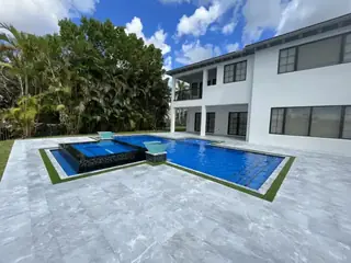 Natural stone pool deck surrounding a South Florida swimming pool — project 01