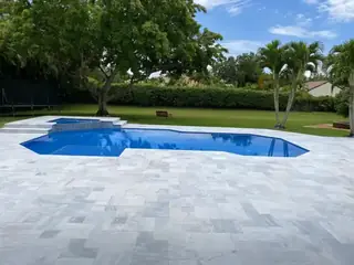 Natural stone pool deck surrounding a South Florida swimming pool — project 05