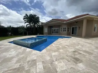 Natural stone pool deck surrounding a South Florida swimming pool — project 06