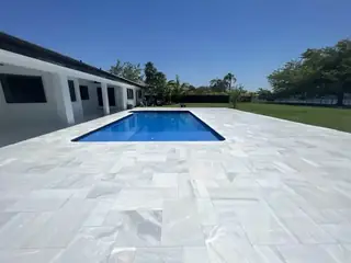 Natural stone pool deck surrounding a South Florida swimming pool — project 07