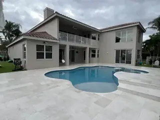 Natural stone pool deck surrounding a South Florida swimming pool — project 08