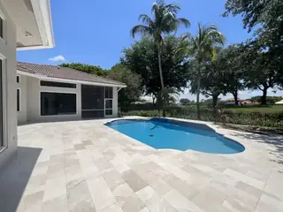 Natural stone pool deck surrounding a South Florida swimming pool — project 12