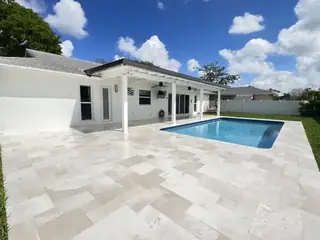 Natural stone pool deck surrounding a South Florida swimming pool — project 16
