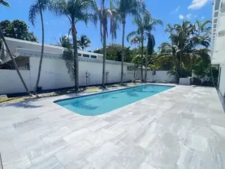 Natural stone pool deck surrounding a South Florida swimming pool — project 17