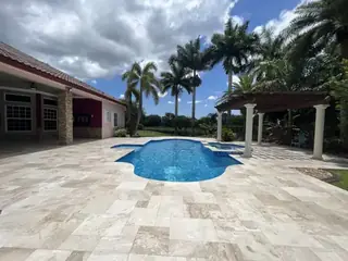 Natural stone pool deck surrounding a South Florida swimming pool — project 18