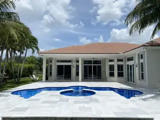Natural stone pool deck surrounding a South Florida swimming pool — project 21