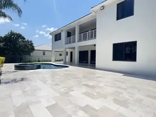 Natural stone pool deck surrounding a South Florida swimming pool — project 22