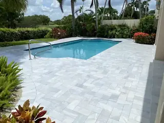 Natural stone pool deck surrounding a South Florida swimming pool — project 23