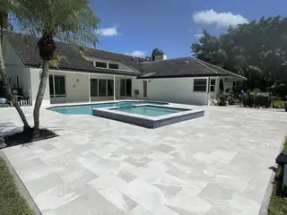 Natural stone pool deck surrounding a South Florida swimming pool — project 24
