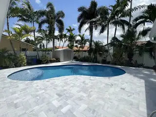 Natural stone pool deck surrounding a South Florida swimming pool — project 25