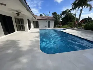 Natural stone pool deck surrounding a South Florida swimming pool — project 26