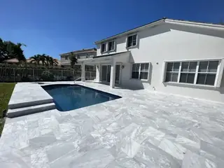 Natural stone pool deck surrounding a South Florida swimming pool — project 27