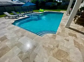 Natural stone pool deck surrounding a South Florida swimming pool — project 28