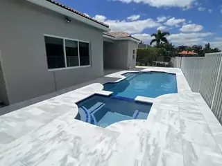 Natural stone pool deck surrounding a South Florida swimming pool — project 29