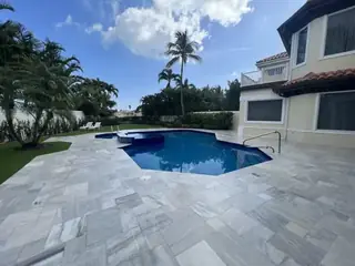 Natural stone pool deck surrounding a South Florida swimming pool — project 31
