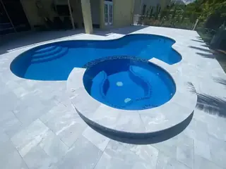 Natural stone pool deck surrounding a South Florida swimming pool — project 33