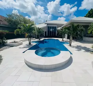 Natural stone pool deck surrounding a South Florida swimming pool — project 34