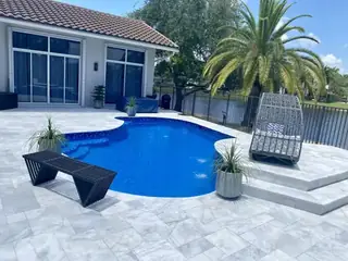 Natural stone pool deck surrounding a South Florida swimming pool — project 35