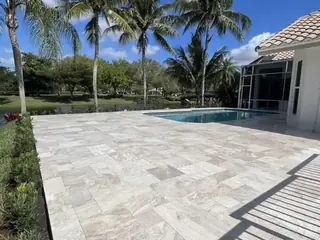Natural stone pool deck surrounding a South Florida swimming pool — project 38