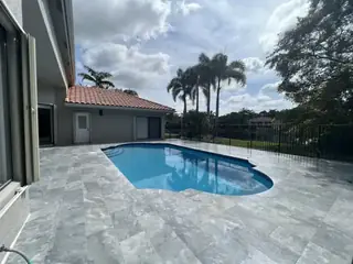 Natural stone pool deck surrounding a South Florida swimming pool — project 39
