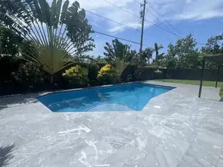 Natural stone pool deck surrounding a South Florida swimming pool — project 41