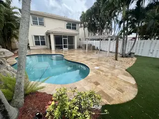 Natural stone pool deck surrounding a South Florida swimming pool — project 42