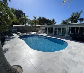 Natural stone pool deck surrounding a South Florida swimming pool — project 43
