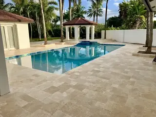 Natural stone pool deck surrounding a South Florida swimming pool — project 46