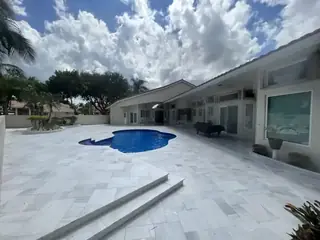 Natural stone pool deck surrounding a South Florida swimming pool — project 47