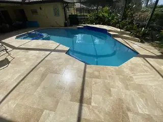 Natural stone pool deck surrounding a South Florida swimming pool — project 48