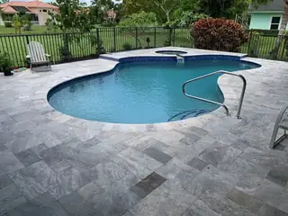 Natural stone pool deck surrounding a South Florida swimming pool — project 49