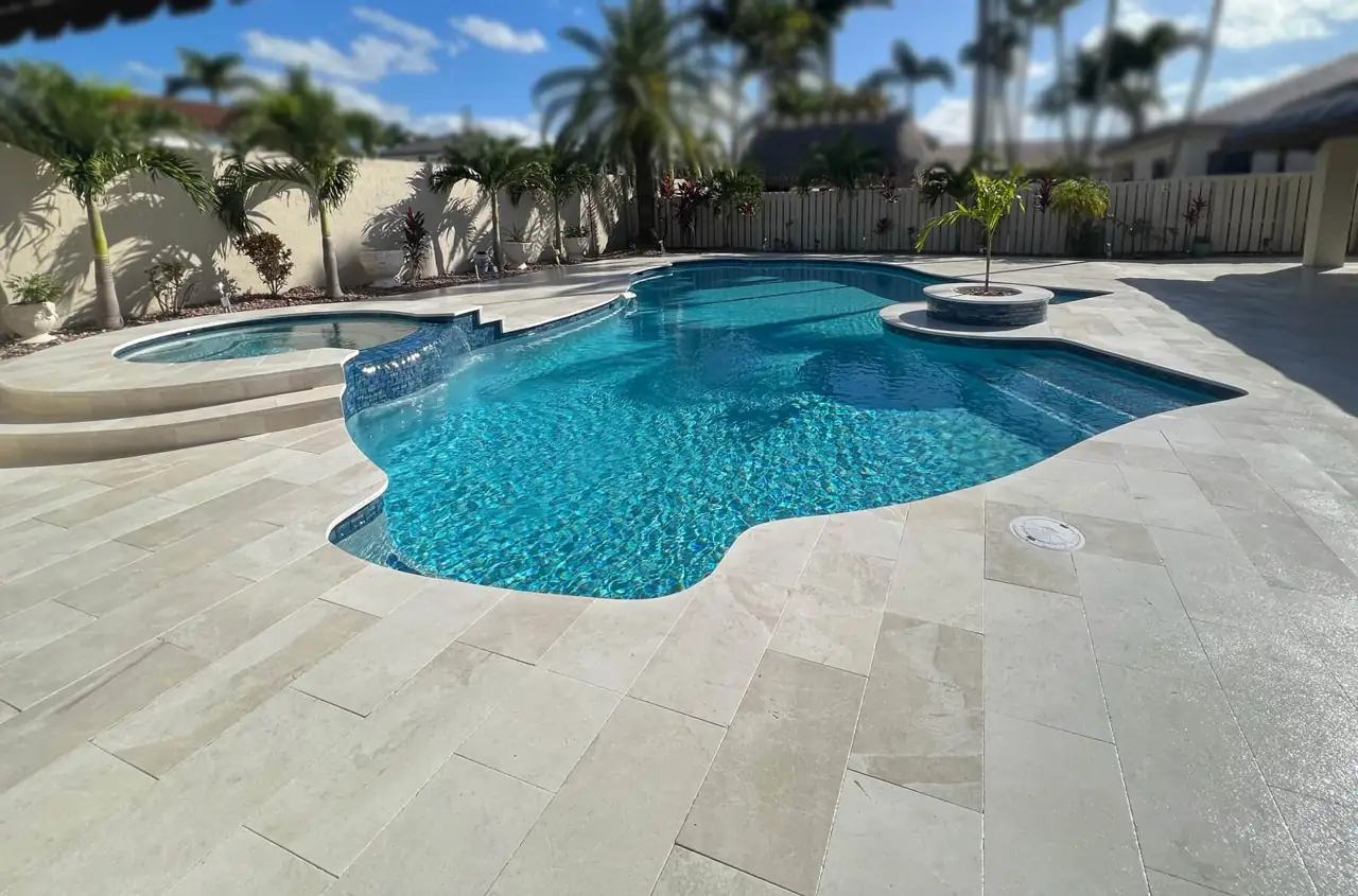 Custom pool remodel with natural stone deck in South Florida